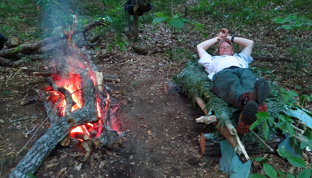 In Alabama, during spring, three adults cooked and slept using a long fire fueled by hardwood to keep warm in the chilly weather.