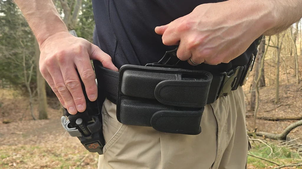 Since your sidearm is always going to be your primary lethal tool, it makes sense to position the knife where you can access it with your offhand.