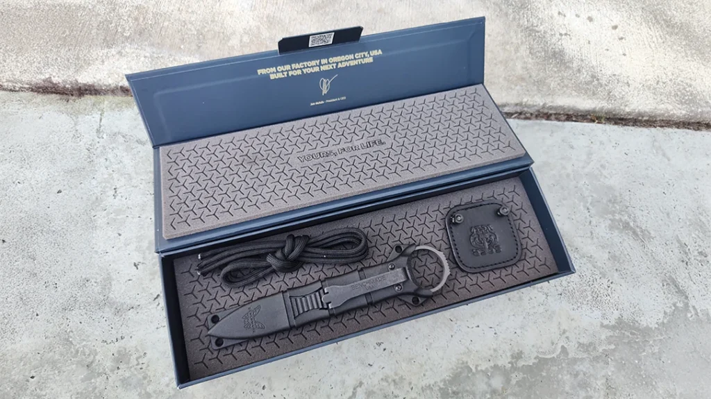 The Benchmade Mini SOCP Dagger is packed securely in a cushioned box with its sheath and attachable cordage.